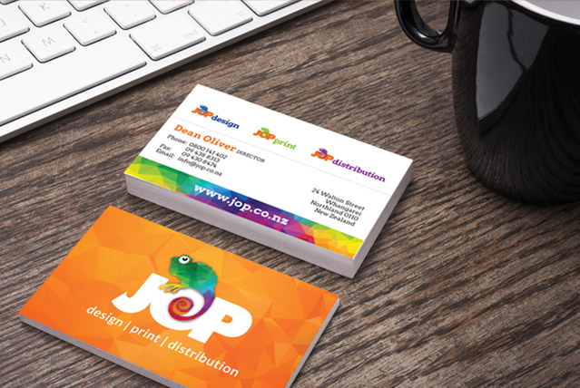 JOP business cards on desk net to coffee mug and laptop keyboard
